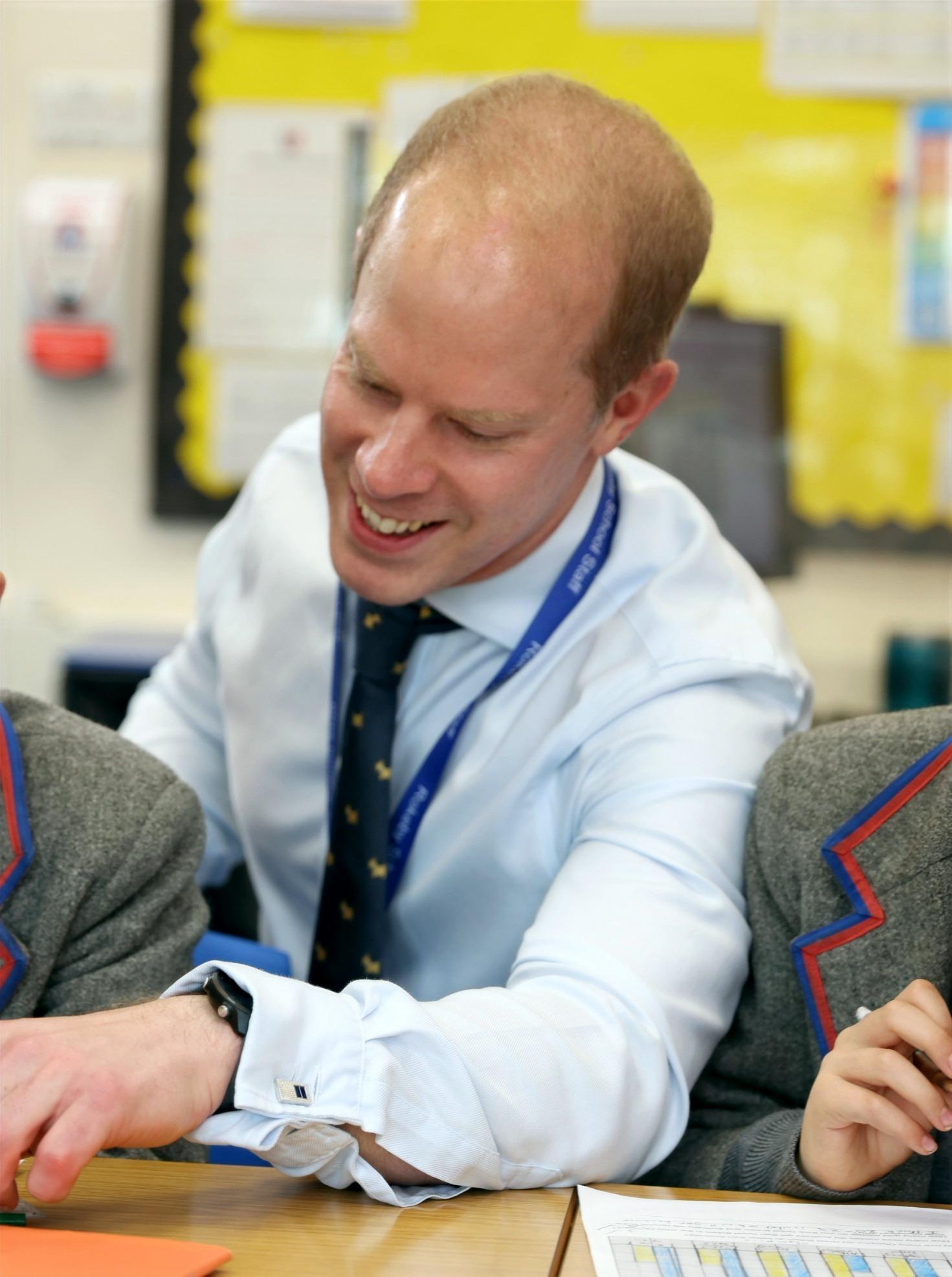 Nick Moore tutoring pupils one-to-one in a classroom